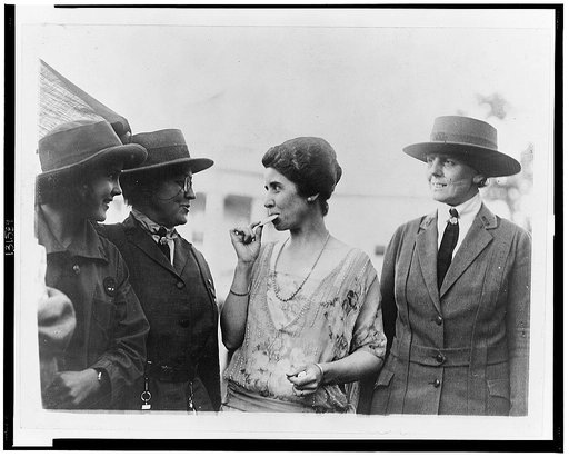 Mrs. Coolidge eating cookies presented by a New York Girl Scout troop