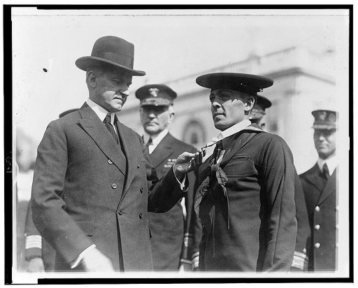 President Coolidge] decorating Henry Breault of the submarine 0-5 with the Congressional Medal of Honor