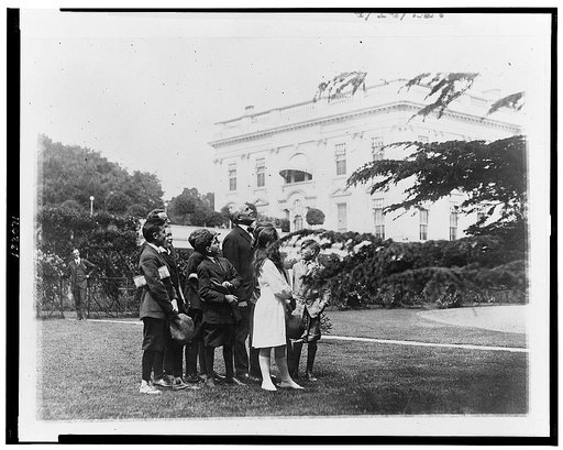 Pointing out an owls nest in the White House grounds to members of the nature study class of John Buroughs [sic] School whom he invited to the White House