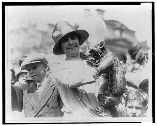 Mrs. Coolidge exhibits her pet raccoon [Rebecca] to crowds of children gathered for Easter egg rolling