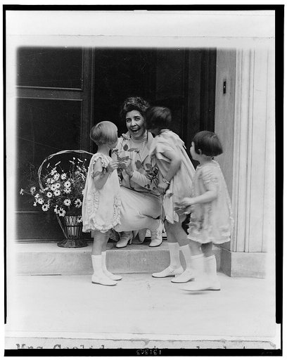 Mrs. Coolidge gets a basket of flowers and a kiss