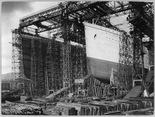 OLYMPIC and TITANIC - view of bows [in shipyard construction scaffolding