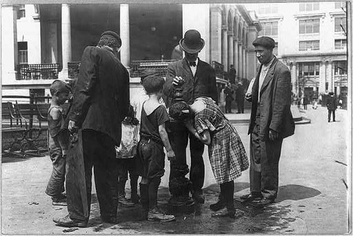 New York City - children on the street: hot weather street scene - On a hot day - people drinking water at a fountain