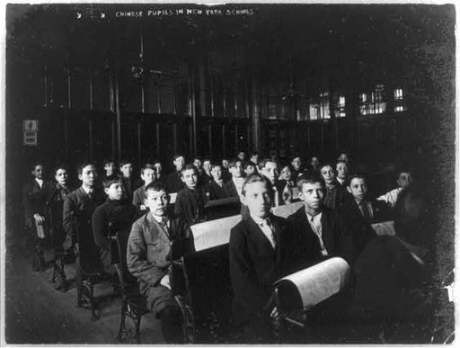Chinese [and other] pupils in a New York School, seated at desks