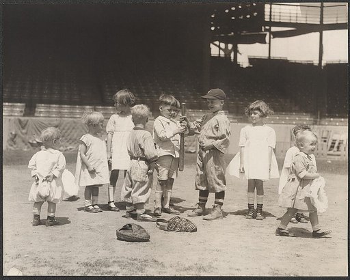 Young boys and girls on the baseball field at a major league stadium