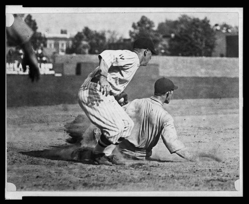 Washington fielder applies tag to ball player sliding into base