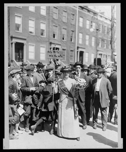 Mrs. Suffern with a home-made banner in the parade