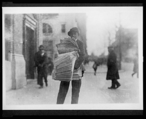 Newsboy on a city street