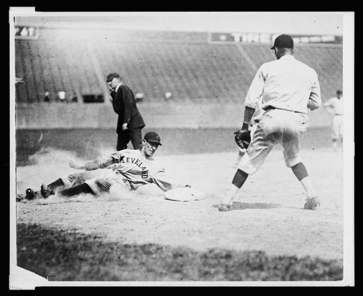 Cleveland base runner, Chick Fewster, slides safely into 3rd base during baseball game between Cleveland and Washington