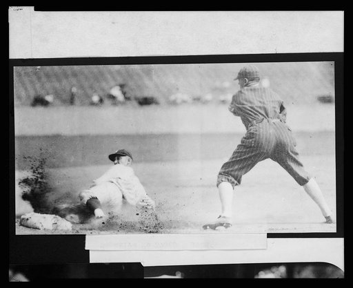 Sam Rice, of the Washington Nationals, sliding safely into 3rd base during baseball game between Washington and the Chicago White Sox