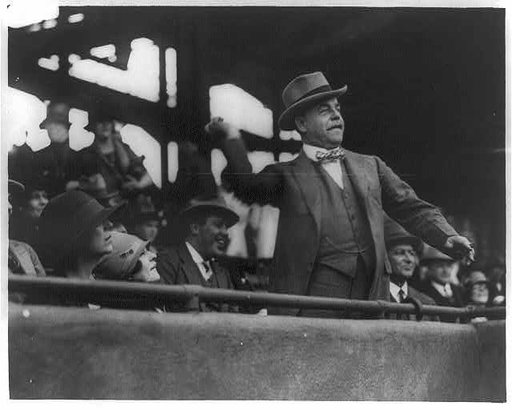 Nicholas Longworth, 1869-1931, Speaker of the House, half-length portrait, standing, facing right, throwing out the first ball at the starting game at American League Park, between the Democratic and Republican teams of the House of Representatives