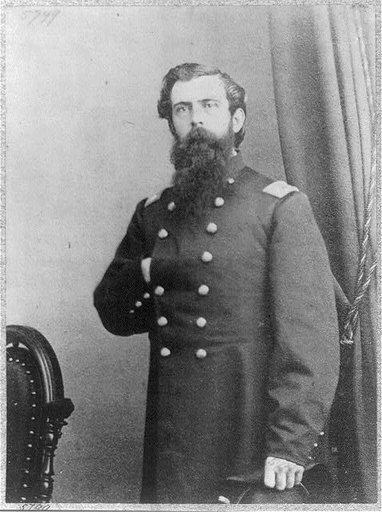 Isaac Sparrow Bangs, b. 1831, half length, standing, right hand inside uniform at chest, facing left