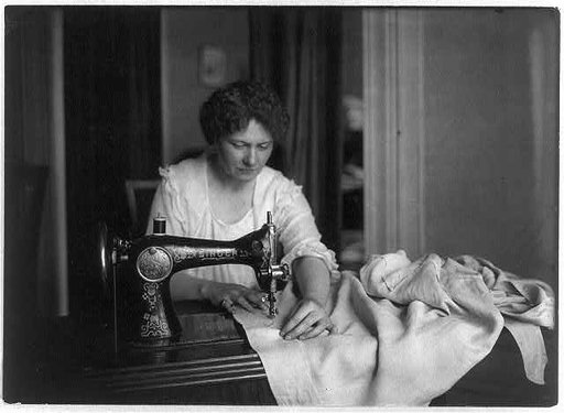 Woman sewing with a Singer sewing machine