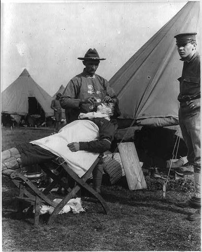 Fort Sam Houston, Tex., 1911-1912: field barber giving a shave
