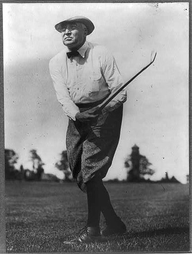 Warren G. Harding, full length, facing left, swinging golf club