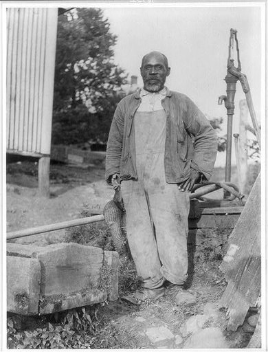 African American man posed in a barnyard near Lewinsville, Va.