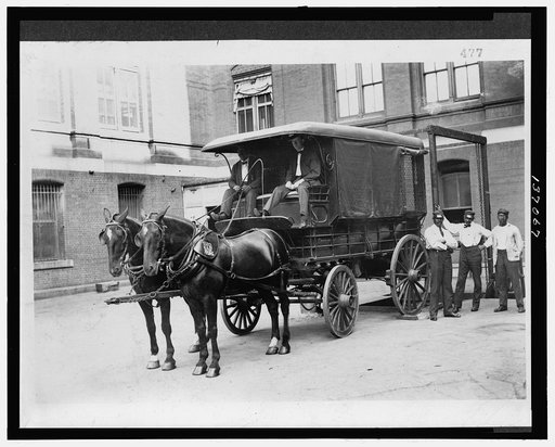 Horse-drawn wagon outside Bureau of Engraving and Printing building