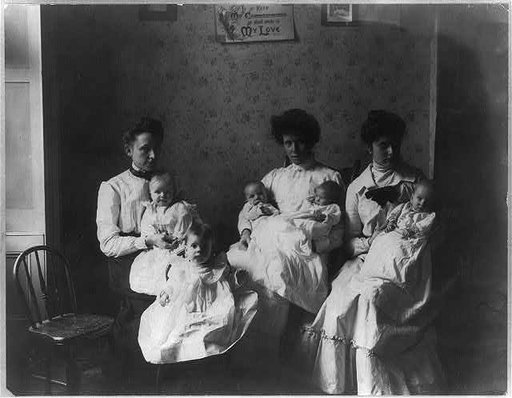 3 women holding 5 babies in day nursery. NYC?
