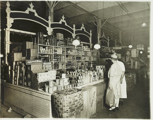 Woman shopping for canned goods at grocery store
