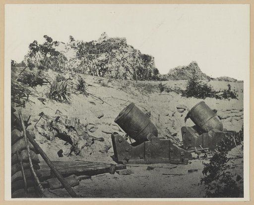 Two trench mortars behind sandbagged barricade