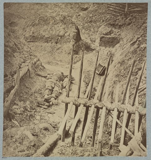 Dead Confederate soldier in trenches of Fort Mahone in front of Petersburg, Va., April 3, 1865