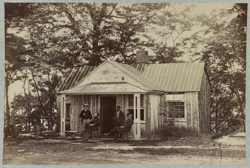 Union army soldiers seated on a porch with three other men