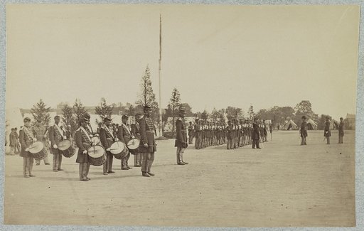 Drum corps stands in front of Union soldiers in formation