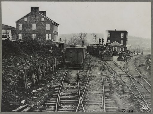 Hanover Junction Pennsylvania, 1863, railroad yards. Detail of tracks, engine, boxcar, and crowd