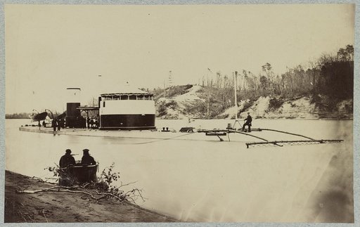 Monitor in Trent's Reach, James River, Va. showing torpedo finder at bow. Butlers "Crow's Nest" and battery on bank of river