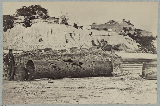 Smoke-stack of Confederate iron-clad Virginia on wharf at Richmond, Va., showing effect of shot in attack on Federal batteries on James River