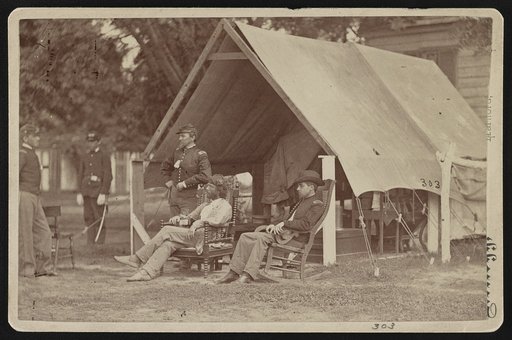 Officers relaxing outside a tent
