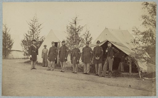 Group of officers lined up in front of the tents