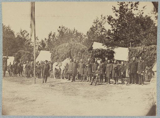 Officers stand in line by a flagpole