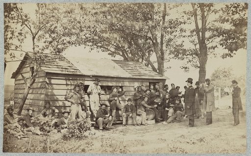 Group of officers and soldiers outside a sutler's store