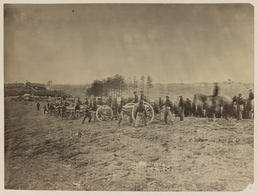 Soldiers preparing cannons on the battlefield