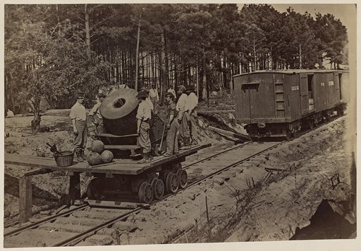 Soldiers with mortar on small railroad car