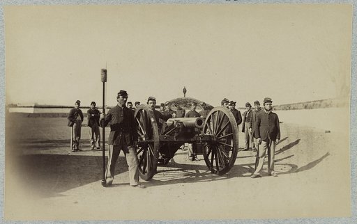 Union soldiers stand around a mounted cannon at a fort