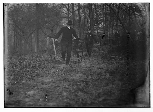 Policeman, police dog chasing tramp, New York City