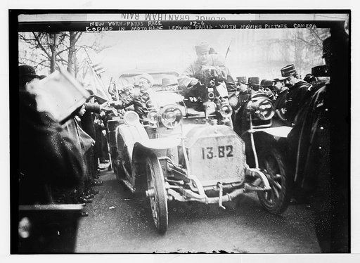 New York - Paris race - Godard in motobloc leaving Paris with moving picture camera, Paris