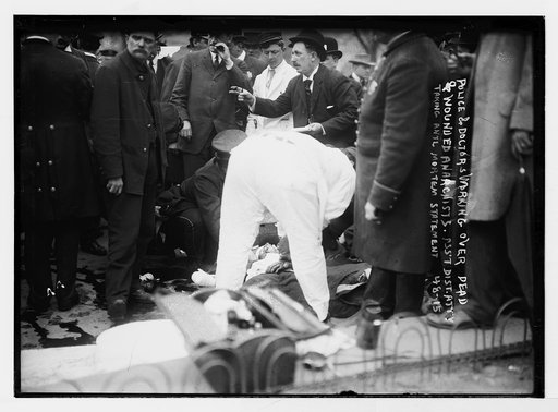 Police and doctors working over dead and wounded anarchists. Ass't. Dist. Atty taking ante mortem statement [Union Square, New York