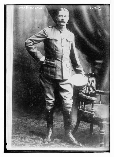 Lord Kitchener, standing by chair, in uniform