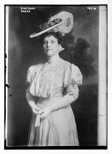 Gertrude Beeks, standing three-quarters