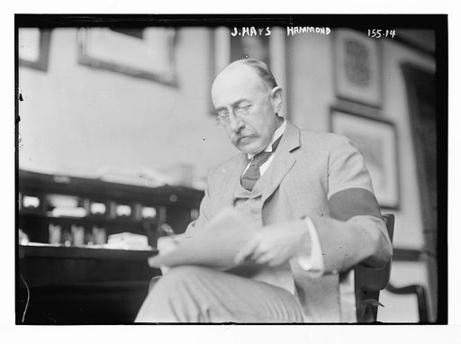 J. Hays Hammond, seated at desk