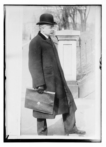 G.B. Cortelyou, carrying briefcase