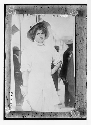 May Sutton, holding tennis racquet