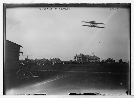 O. Wright flying [in his airplane, crowd on field