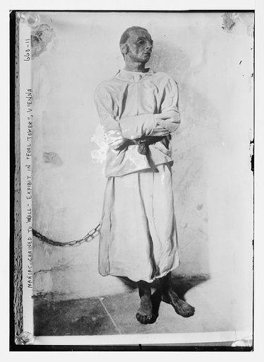 Maniac man chained to wall, exhibit in "Fool Tower", Vienna