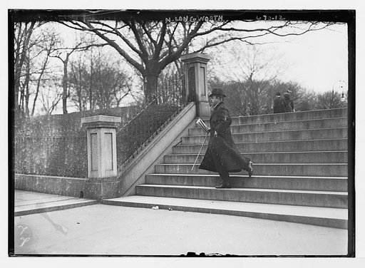 N. Longworth, decending steps, in topcoat, top hat, and cane
