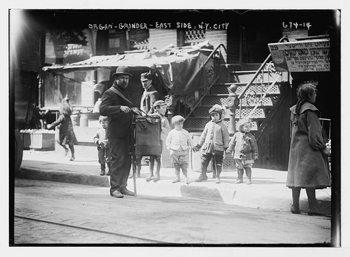 Organ grinder on street, East Side, New York