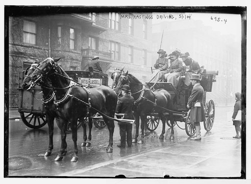 Mrs. Hastings, seated next to other women, driving coach, New York